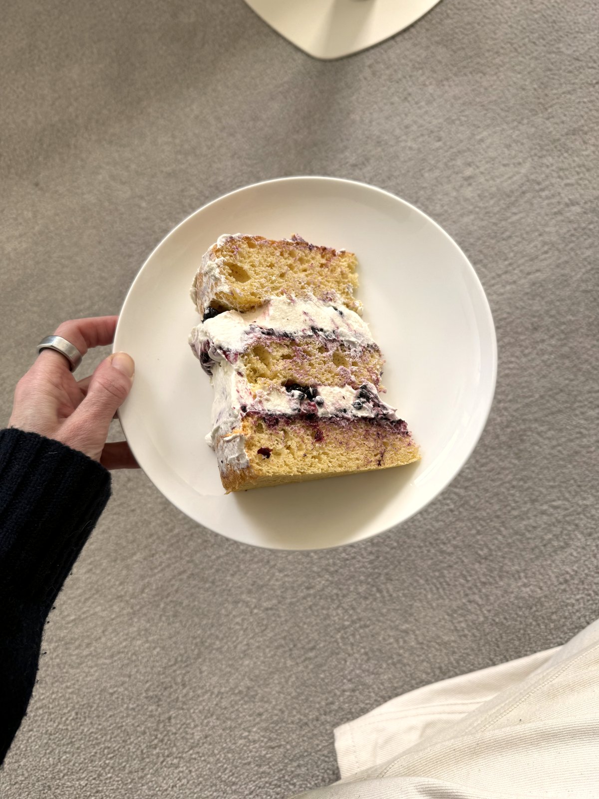 A slice of the genoise — cream and blackberry jam through the middle